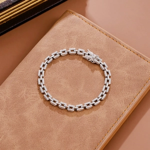 925 silver bracelet with pavé zircon rectangle links on a brown leather texture