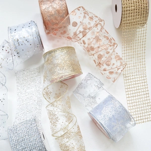 Macro shot of chiffon snowflake and polka dot gift ribbons in gold and silver