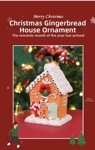 Close-up of festive gingerbread house ornament with snow roof and tiny gingerbread man