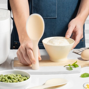 Standing silicone rice paddle in cream white, heat resistant with ergonomic non-stick handle