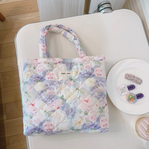 Detail of floral quilted handbag with diamond stitching and simple wish fabric label