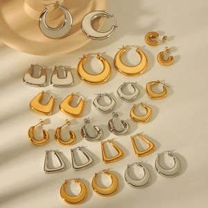 Assorted geometric 18K gold and silver stainless steel hoop earrings on beige background