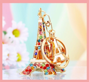 Macro shot of gold Eiffel Tower keychain with colorful crystals and polished mini pendant