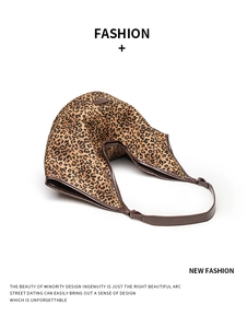 Detailed close-up of leopard print tote bag with brown trim and premium canvas texture
