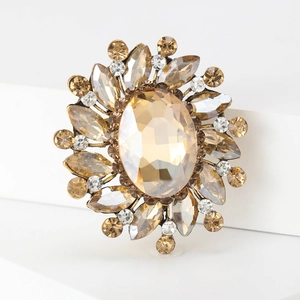 Detail of vintage champagne crystal brooch with rhinestones on bronze floral base