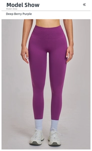 Detail of seamless high waist yoga pants in deep berry purple with smooth knit texture