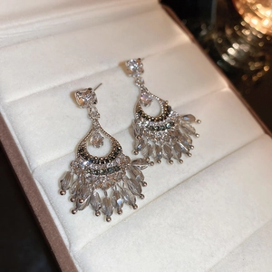 Vintage silver flower tassel earrings with grey crystal drops in a beige jewelry box