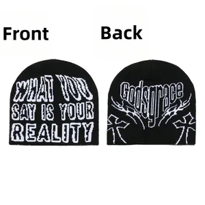 Front and back detail of a black knit beanie with white cross and letter jacquard patterns
