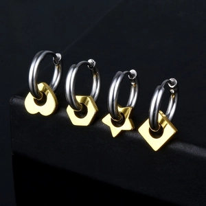 Detail of four geometric charm hoop earrings in silver and gold stainless steel finish