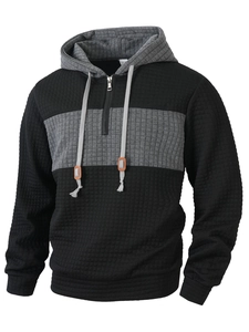 Detail of waffle knit fabric and 1/4 zipper closure on men's color-block hoodie