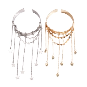 Metallic star and heart tassel open arm cuffs in gold and silver finish on white background