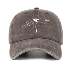 Detailed front view of washed brown baseball cap with white dragonfly print graphic