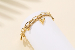 Close-up of double-layer gold titanium steel heart bracelet on elegant display