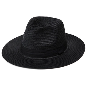 Macro detail of the premium black straw weaving and silk ribbon on the wide brim sun hat