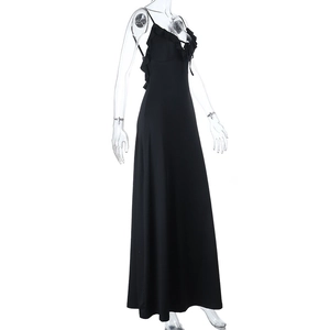 Detail of elegant black evening dress featuring deep V-neck and delicate ruffle neckline