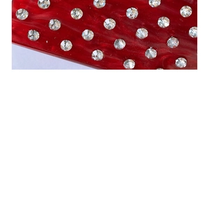 Detail of red water ripple acetate material with sparkling rhinestones for handbags