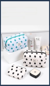 Three-piece quilted makeup bag set with delicate floral embroidery and zipper closure