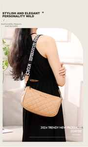 Detail of beige quilted crossbody bag with decorative black wide fabric shoulder strap