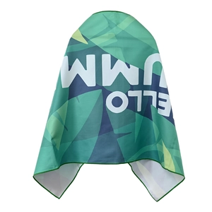 Detail of quick-dry towel showing tropical leaf pattern and green overlock stitching edge