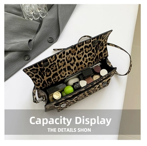 Top view of leopard print crossbody bag showing interior space for cosmetics
