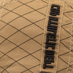 Close-up of khaki quilted cotton beret featuring black CORDUROY DEPT embroidery detail