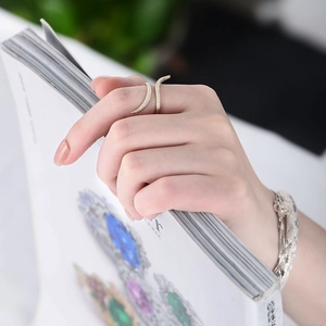 Detail of adjustable gold ring with micro-pave cubic zirconia on a model's finger