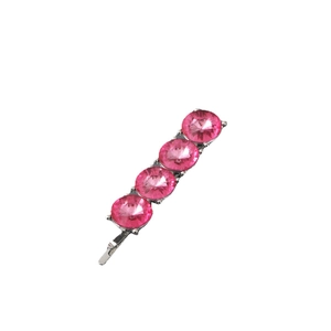 Detailed close-up of a silver hair pin featuring four sparkling pink faceted rhinestones