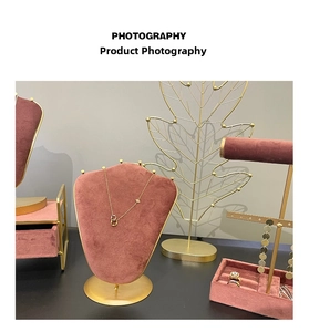 Detail of velvet necklace bust and gold metal jewelry display stand in dusty rose color