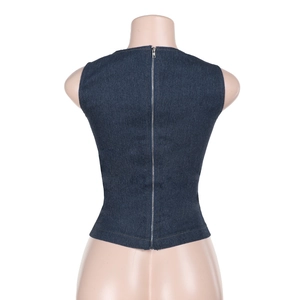 Detail shot of full-length metal zipper on the back of a dark blue denim crop top