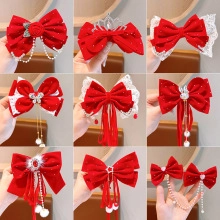 Collage of red bow hair clips with pearls and tassels for kids hanfu styling