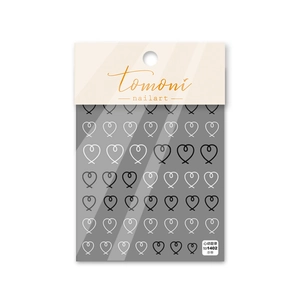 Close-up of 5D embossed heart pattern nail art stickers with black and white line details