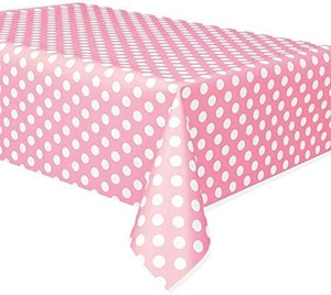 Detailed close-up of pink disposable tablecloth with white polka dots for birthday parties