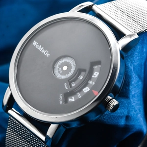 Close-up of minimalist silver mesh watch featuring a unique black rotating dial