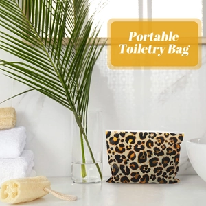 Leopard print EVA makeup bag on a bathroom counter with tropical leaves and a towel