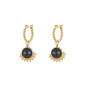 Detail of gold starburst earrings with black stone inlay and twisted rope hoop design