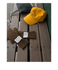 Brown knitted wool gloves with vintage label and yellow embroidered baseball cap