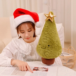 Detailed view of a plush Christmas tree toy with soft green fur and a gold star decoration