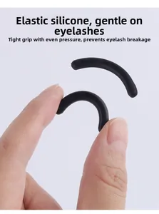 Macro detail of black elastic silicone eyelash curler refill pads showing soft flexibility