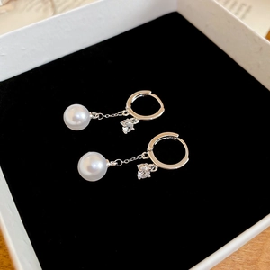 Macro detail of French style pearl tassel earrings with zircon in a premium gift box