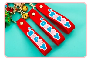 Red silicone Christmas keychain with Beppy letters, golden bell and green tree charm
