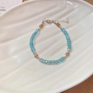 Detail of beaded bracelet with blue crystal beads and silver lobster clasp closure