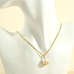 Detail of white pearl pendant with gold claw setting on a twisted rope chain necklace