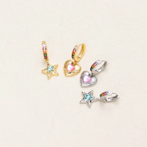 Detailed view of asymmetric gold star and heart earrings with colorful zircon inlay