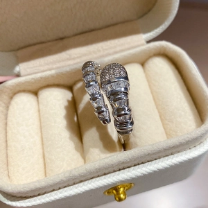 Macro view of silver snake ring with pavé-set zircons on textured spiral band