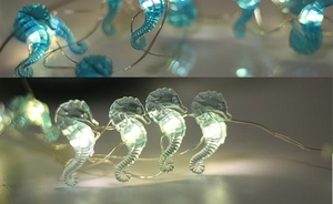 Close-up of seahorse-shaped LED string lights with warm glowing beads on flexible wires