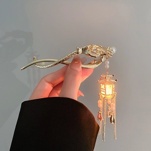 Golden Chinese lantern hair pin with glowing LED light and elegant pearl tassels
