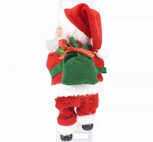 Detail of climbing Santa Claus doll in red velvet with green sack on white background