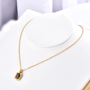 French vintage gold chain necklace featuring an irregular black oval zircon pendant