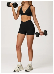 Close-up of high-waisted yoga shorts with V-cross waistband and convenient side pockets