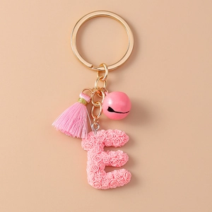 Pink letter E keychain with floral texture, tassel and bell on golden clasp